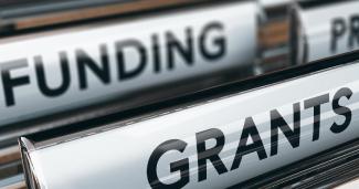 File folders with tabs that read Funding and Grants